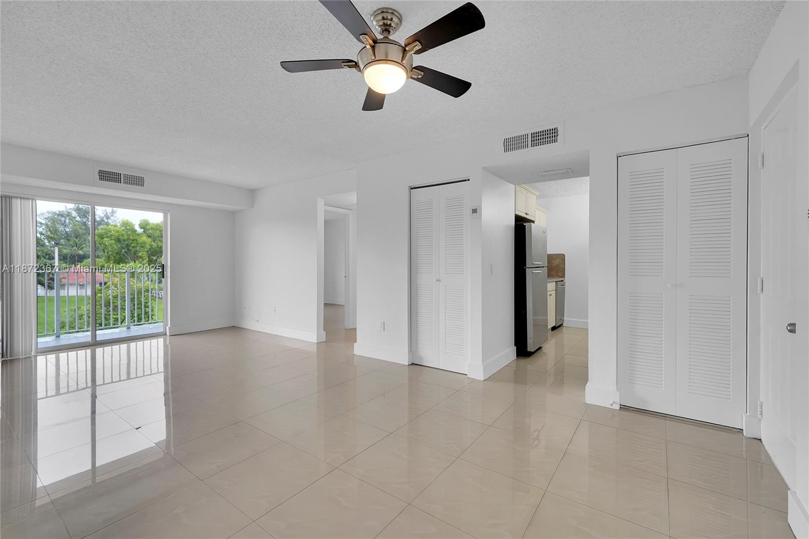 8260 Southwest 210th Street, Unit 201 Cutler Bay, FL 33189 - Photo 1 of 33 a view of a livingroom with a ceiling fan and window