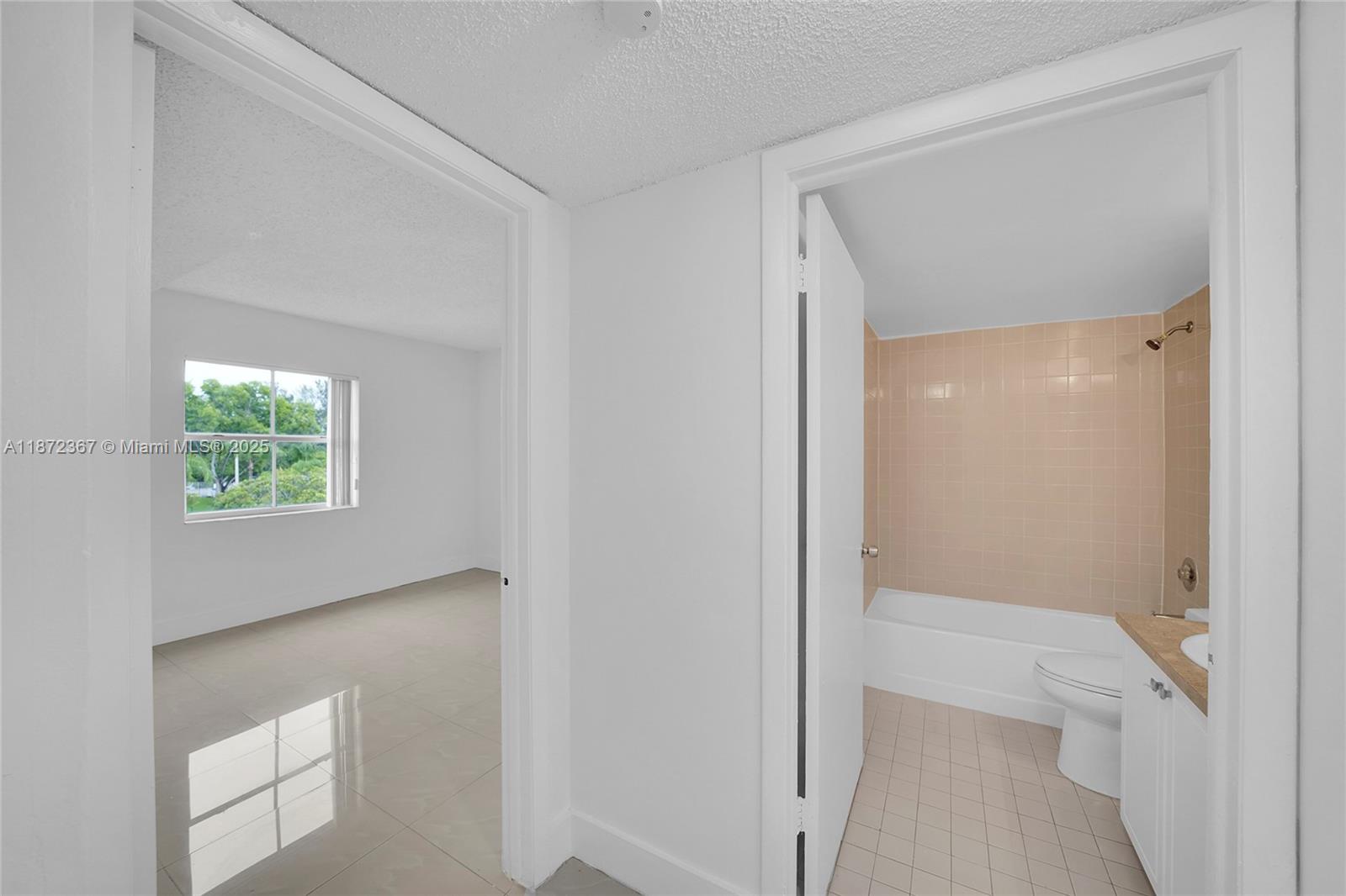 8260 Southwest 210th Street, Unit 201 Cutler Bay, FL 33189 - Photo 14 of 33 a bathroom with a glass shower door