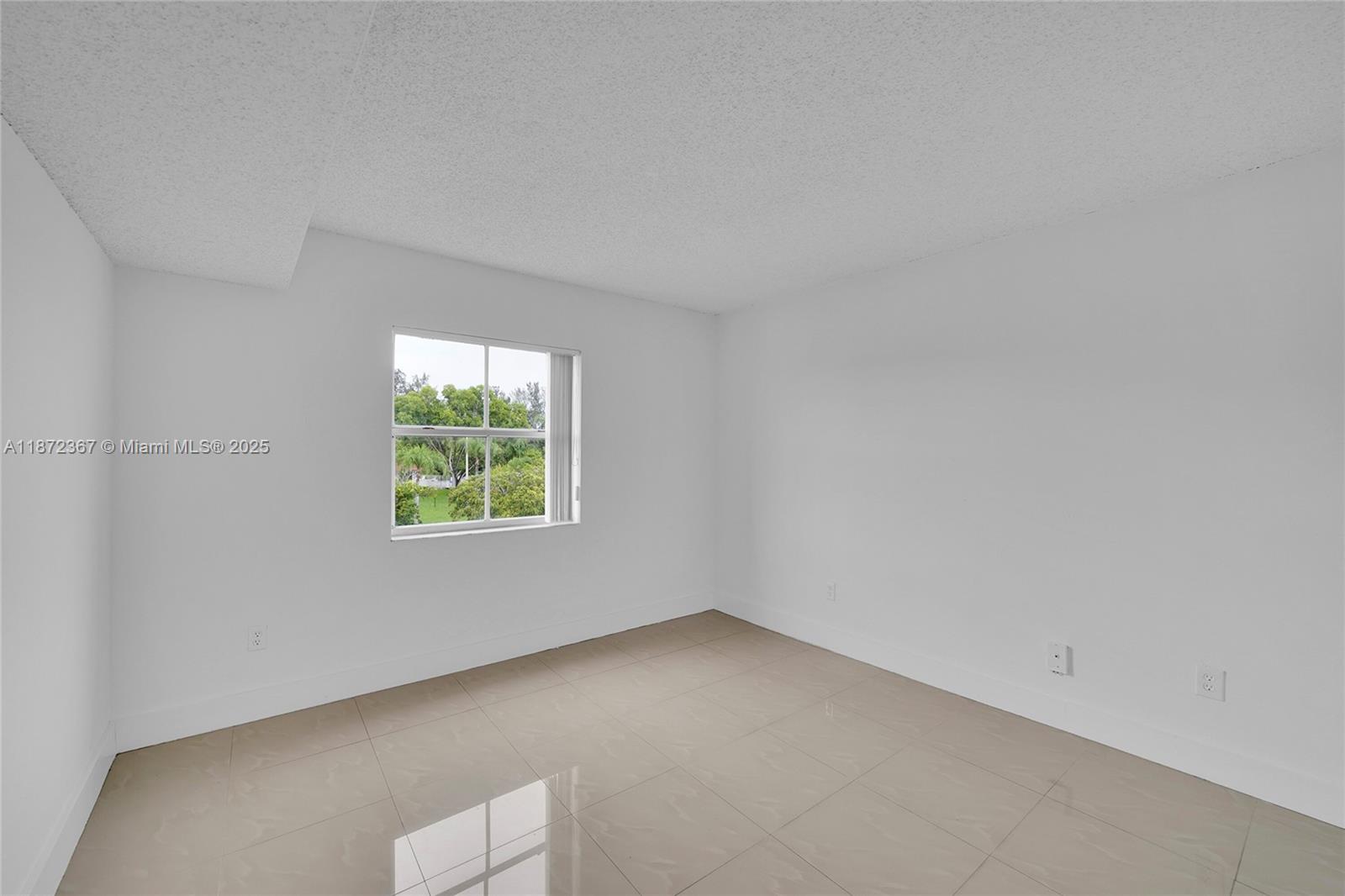 8260 Southwest 210th Street, Unit 201 Cutler Bay, FL 33189 - Photo 15 of 33 an empty room with a window