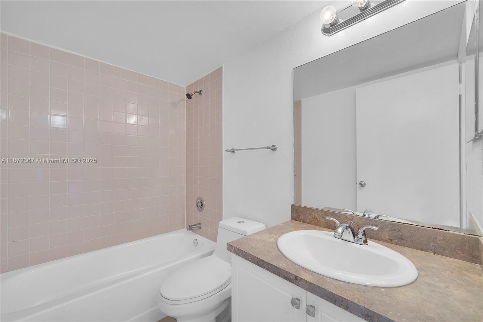 8260 Southwest 210th Street, Unit 201 Cutler Bay, FL 33189 - Photo 18 of 33 a bathroom with a sink a toilet and shower