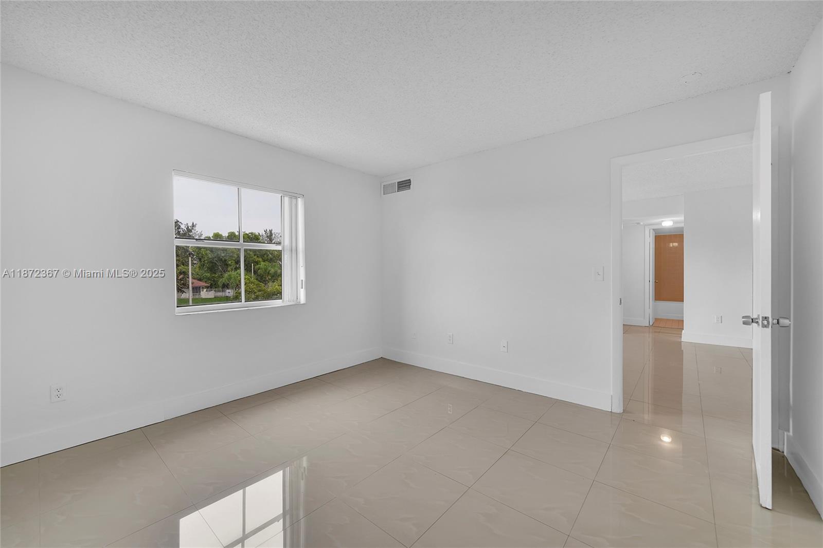 8260 Southwest 210th Street, Unit 201 Cutler Bay, FL 33189 - Photo 20 of 33 an empty room with windows