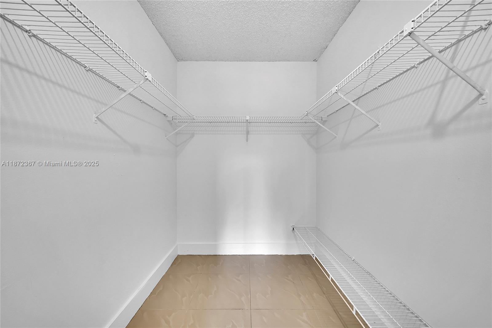 8260 Southwest 210th Street, Unit 201 Cutler Bay, FL 33189 - Photo 22 of 33 a view of a room with racks on the wall