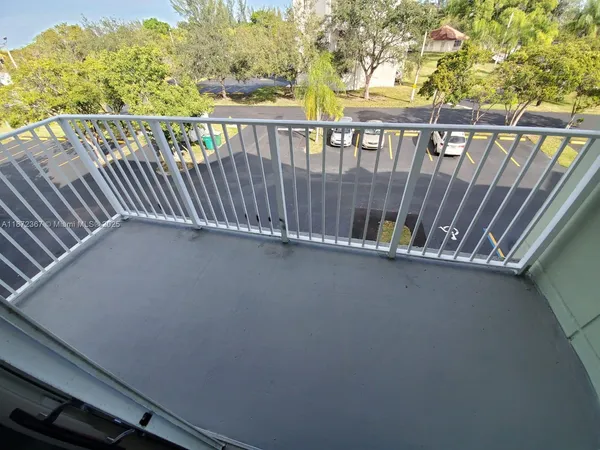 a view of balcony with wooden floor
