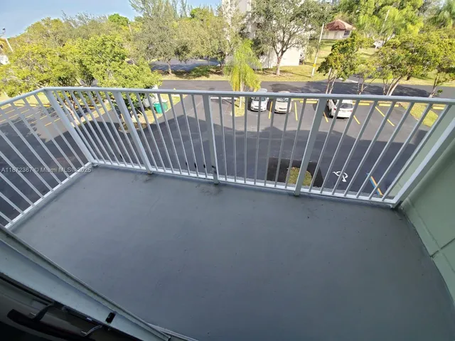 a view of balcony with wooden floor