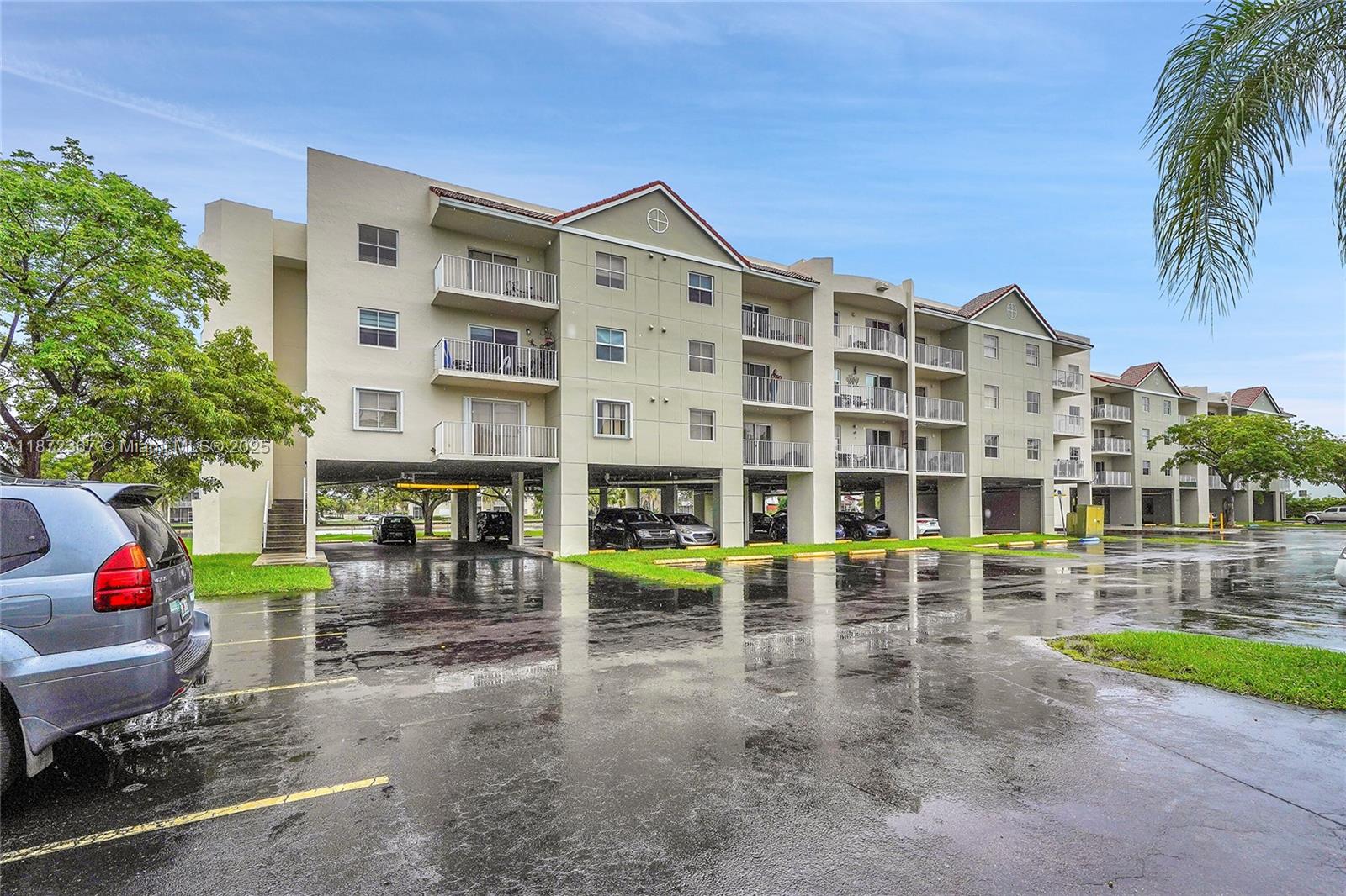 8260 Southwest 210th Street, Unit 201 Cutler Bay, FL 33189 - Photo 30 of 33 front view of a building with a garden
