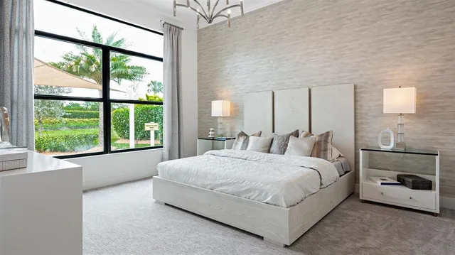 a large bed sitting in a bedroom next to a window