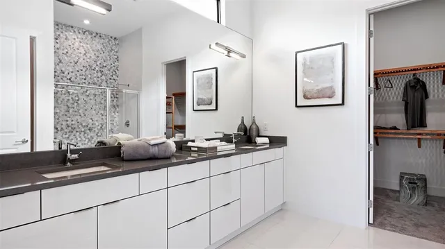 a bathroom with a double vanity sink and mirror