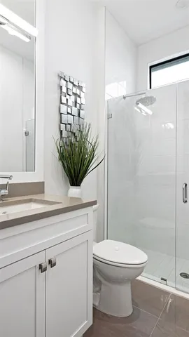 a bathroom with a toilet a sink and shower