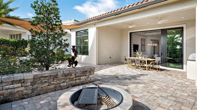 a view of a patio with table and chairs and potted plants