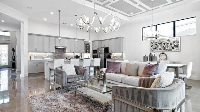 a living room with furniture and kitchen view