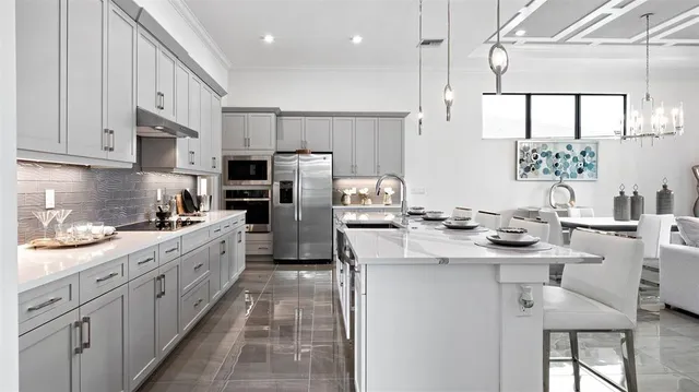 a kitchen with stainless steel appliances kitchen island granite countertop a sink and cabinets