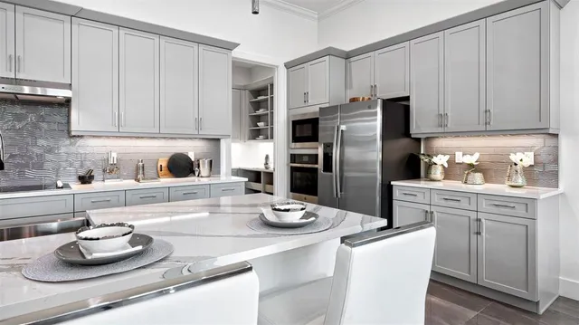 a kitchen with stainless steel appliances granite countertop a sink a stove and refrigerator