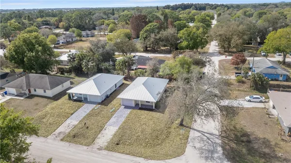 an aerial view of a house with a yard and lake view