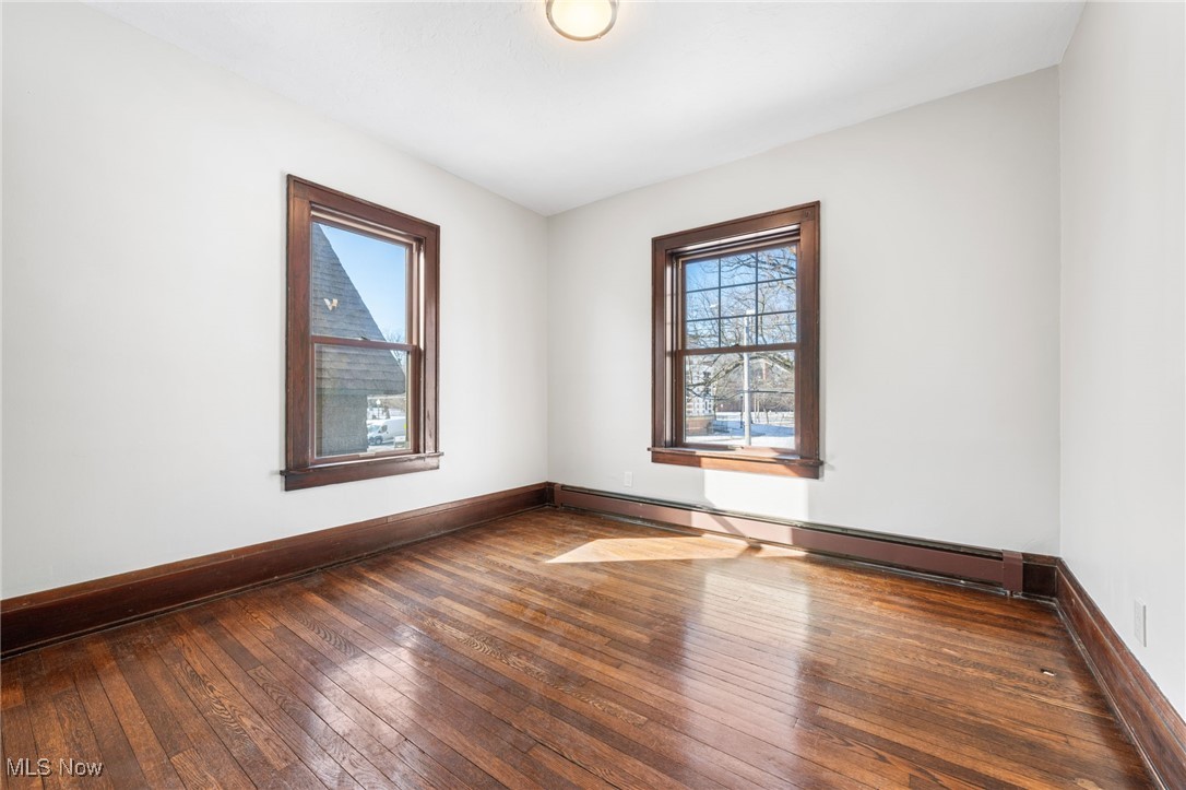 1905 Fulton Road, Unit 2B Cleveland, OH 44113 - Photo 19 of 31 Unfurnished room with dark hardwood / wood-style flooring and a baseboard heating unit