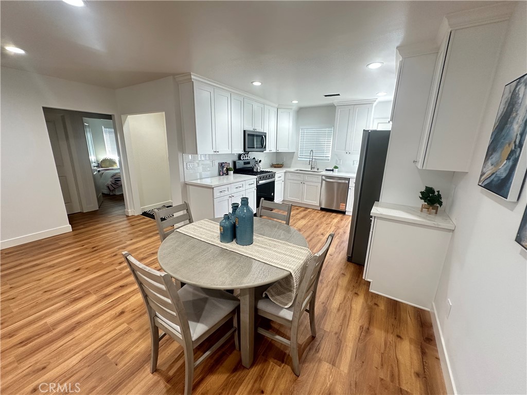 12158 Oracle Street Norwalk, CA 90650 - Photo 1 of 22 a view of a dining room with furniture and wooden floor