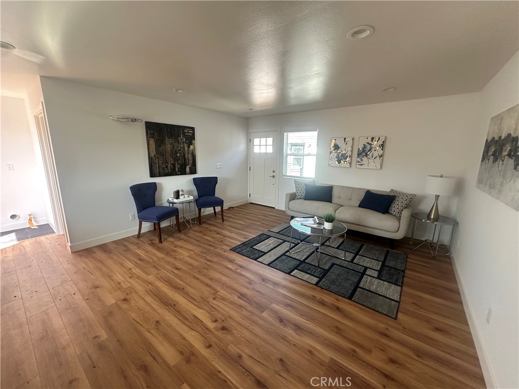 12158 Oracle Street Norwalk, CA 90650 - Photo 11 of 22 a living room with furniture and a wooden floor