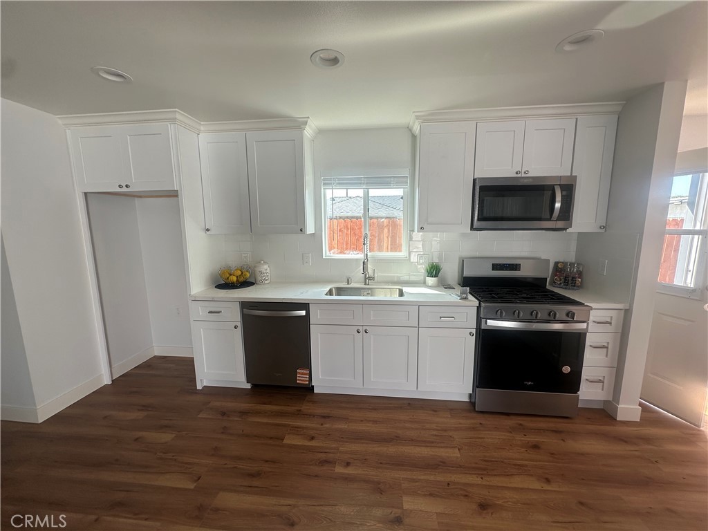12158 Oracle Street Norwalk, CA 90650 - Photo 12 of 22 a kitchen with a refrigerator stove and microwave