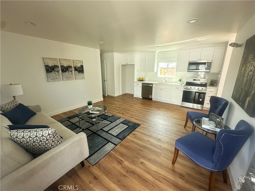 12158 Oracle Street Norwalk, CA 90650 - Photo 13 of 22 a living room with furniture rug and window