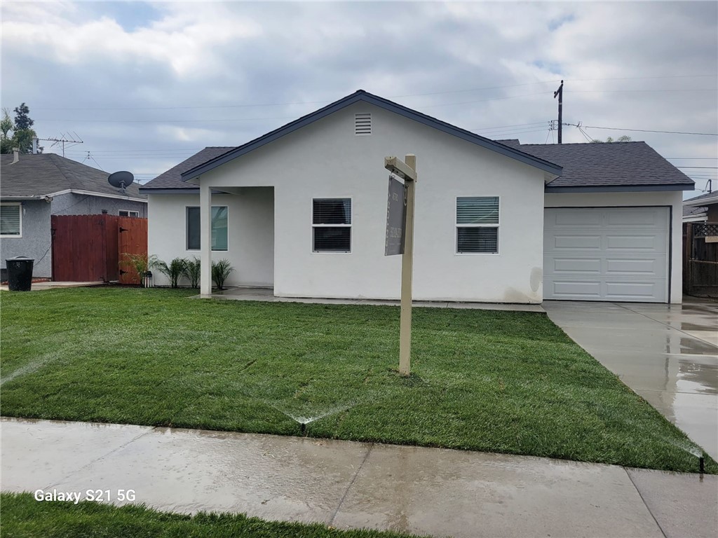 12158 Oracle Street Norwalk, CA 90650 - Photo 17 of 22 a front view of house with yard