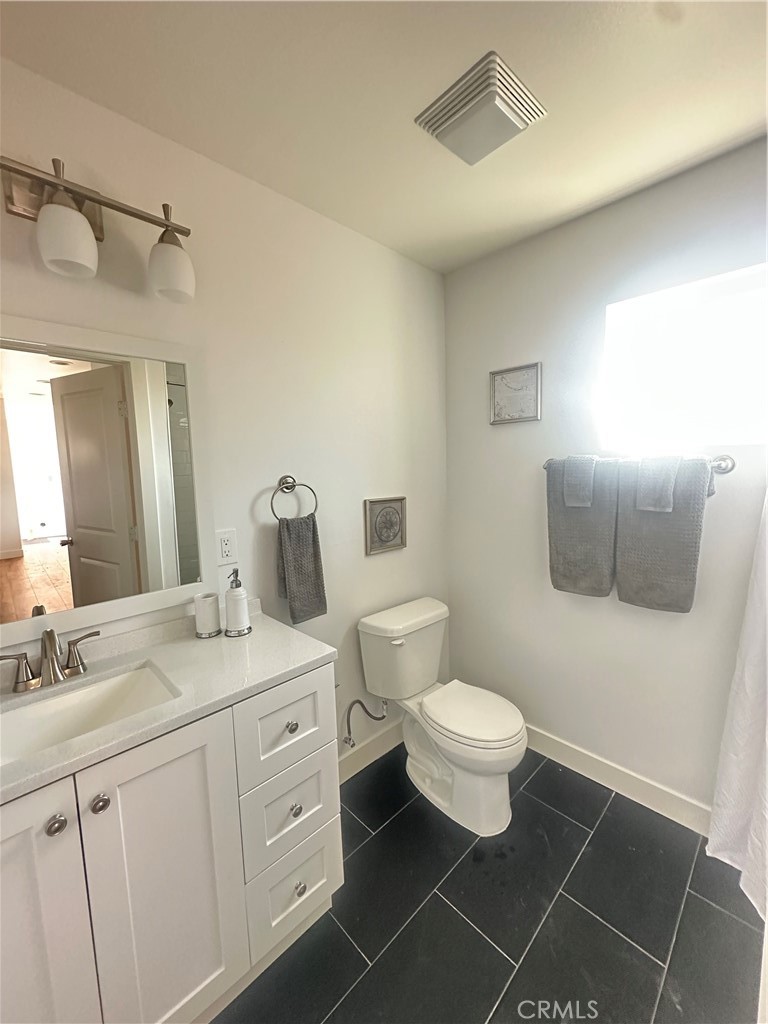 12158 Oracle Street Norwalk, CA 90650 - Photo 8 of 22 a bathroom with a toilet sink and mirror