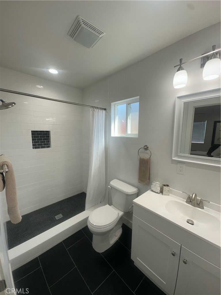 12158 Oracle Street Norwalk, CA 90650 - Photo 9 of 22 a bathroom with a toilet sink and mirror