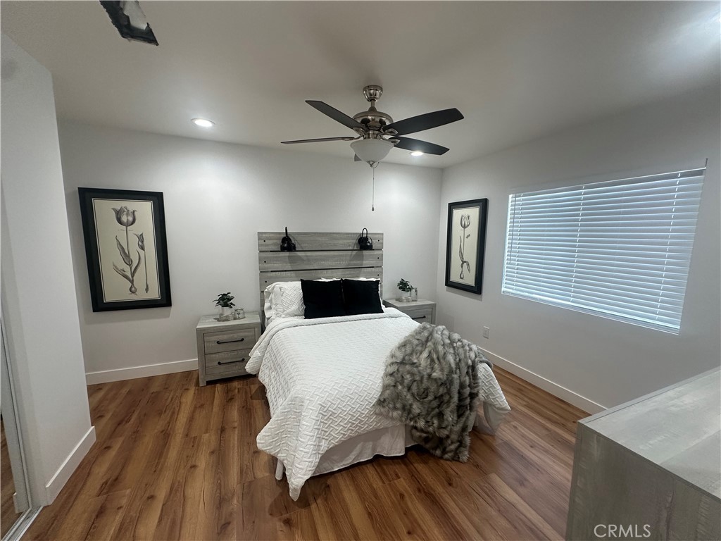 12158 Oracle Street Norwalk, CA 90650 - Photo 10 of 22 a bedroom with a bed and a dresser with rug