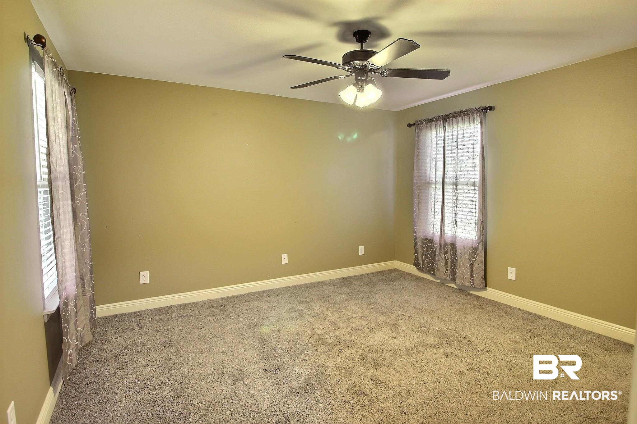 15577 Talus Court Foley, AL 36535 - Photo 11 of 28 Carpeted empty room with baseboards and ceiling fan