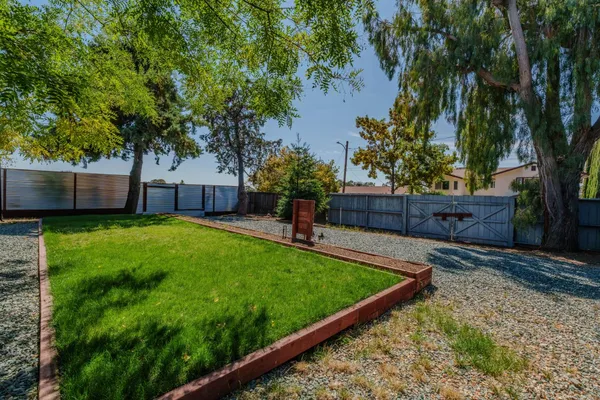 a kitchen with stainless steel appliances granite countertop a stove a sink dishwasher and cabinets with wooden floor