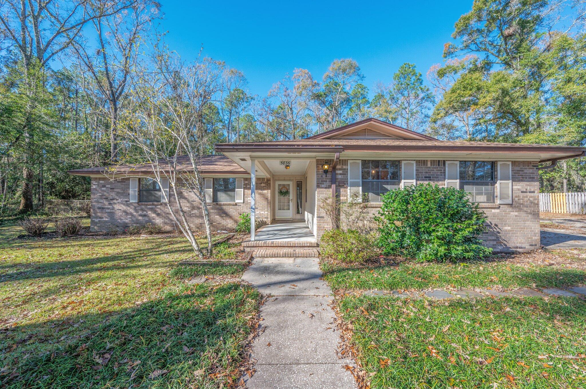 5836 Dairy Road Baker, FL 32531 - Photo 1 of 65 a view of a house with backyard and sitting area