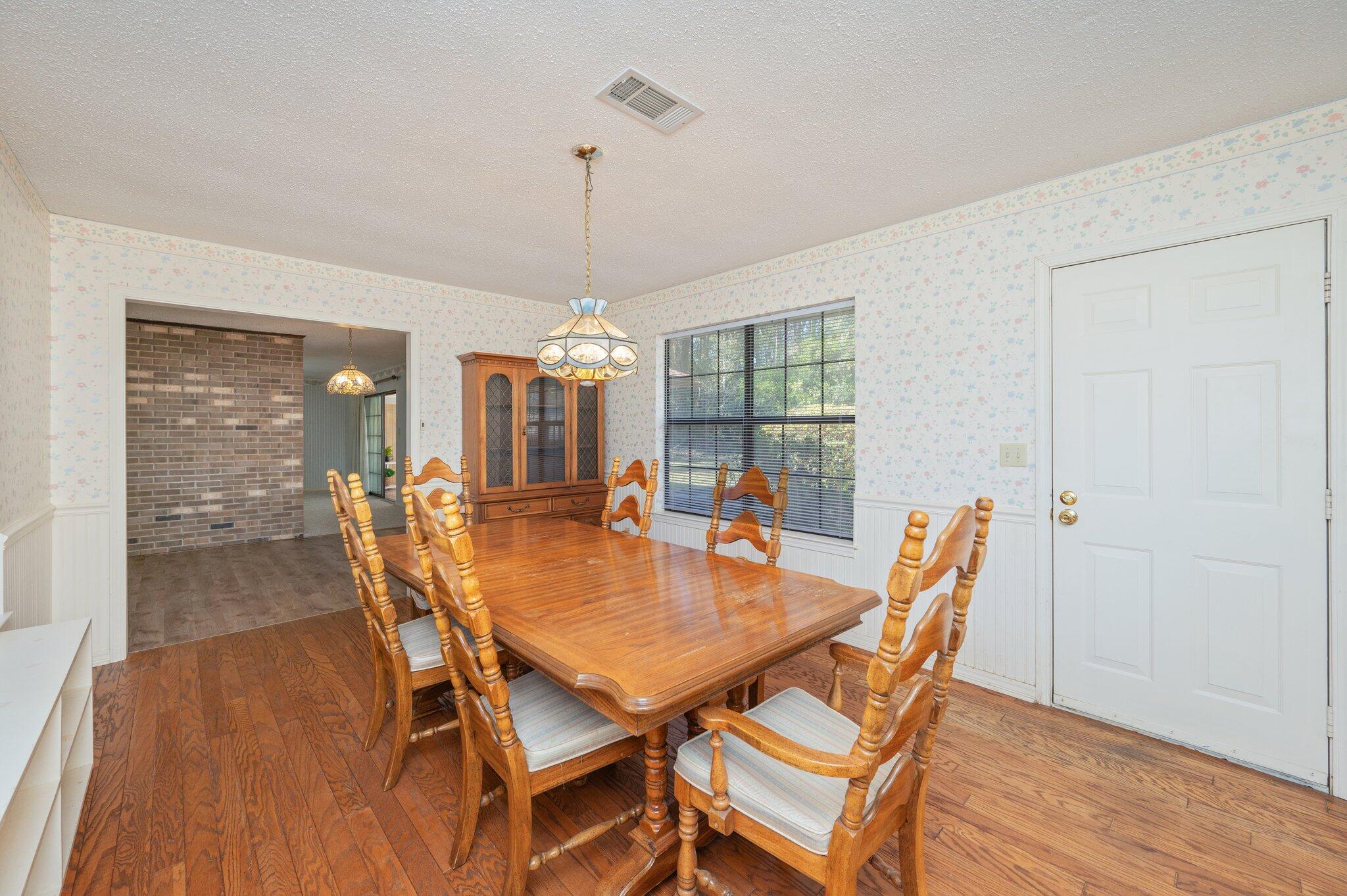 5836 Dairy Road Baker, FL 32531 - Photo 28 of 65 a view of a dining room with furniture window and wooden floor