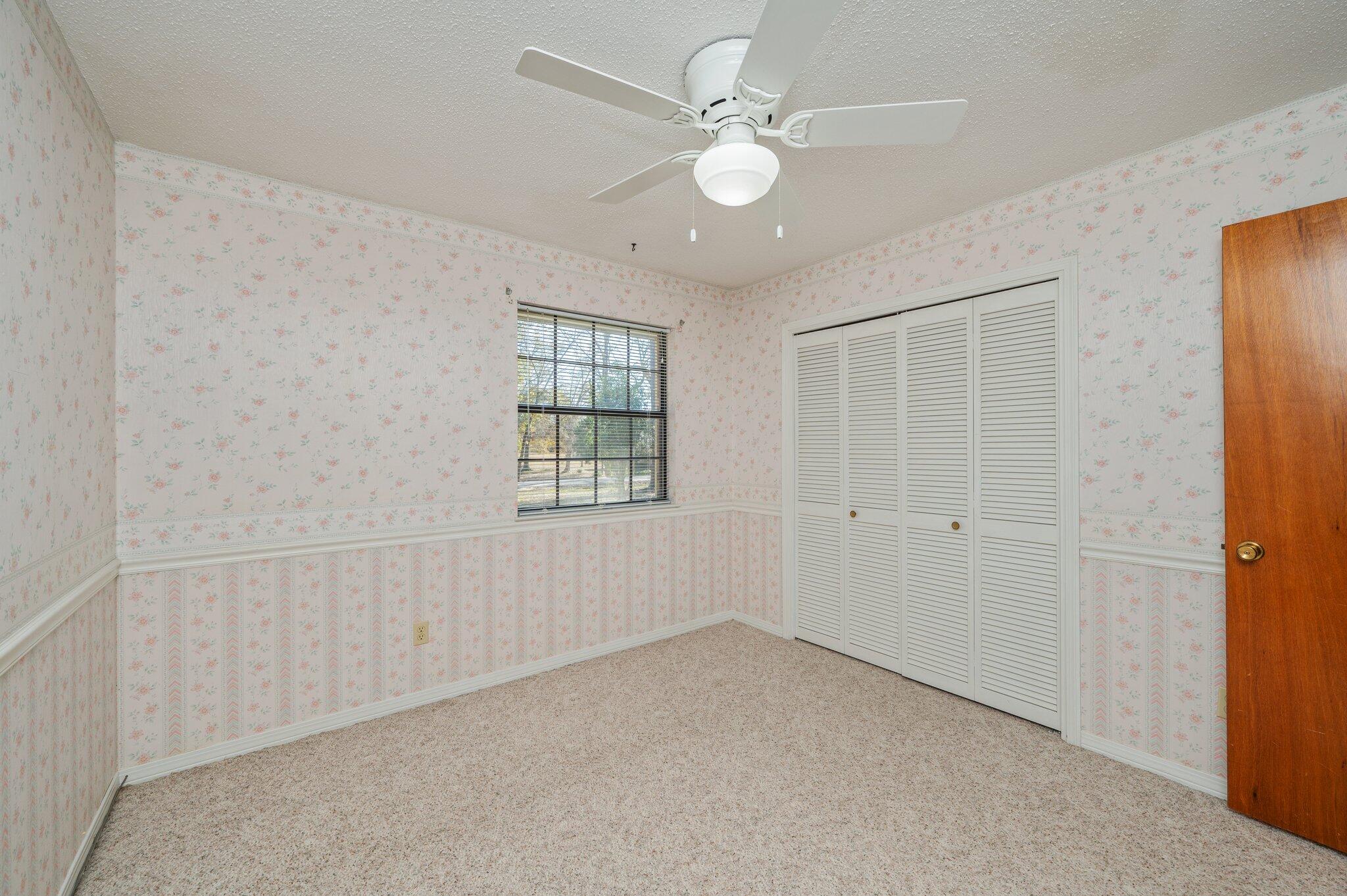 5836 Dairy Road Baker, FL 32531 - Photo 39 of 65 an empty room with windows and fan