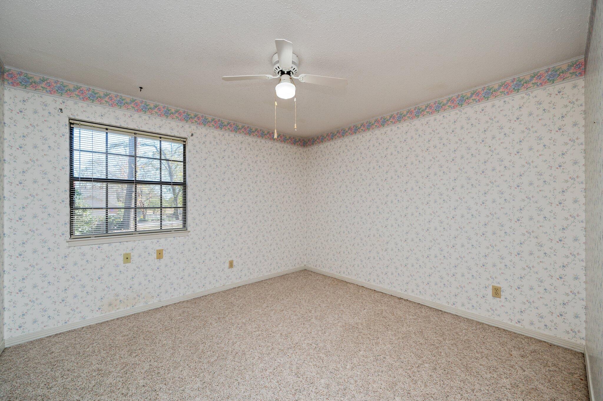 5836 Dairy Road Baker, FL 32531 - Photo 40 of 65 an empty room with chandelier fan and windows