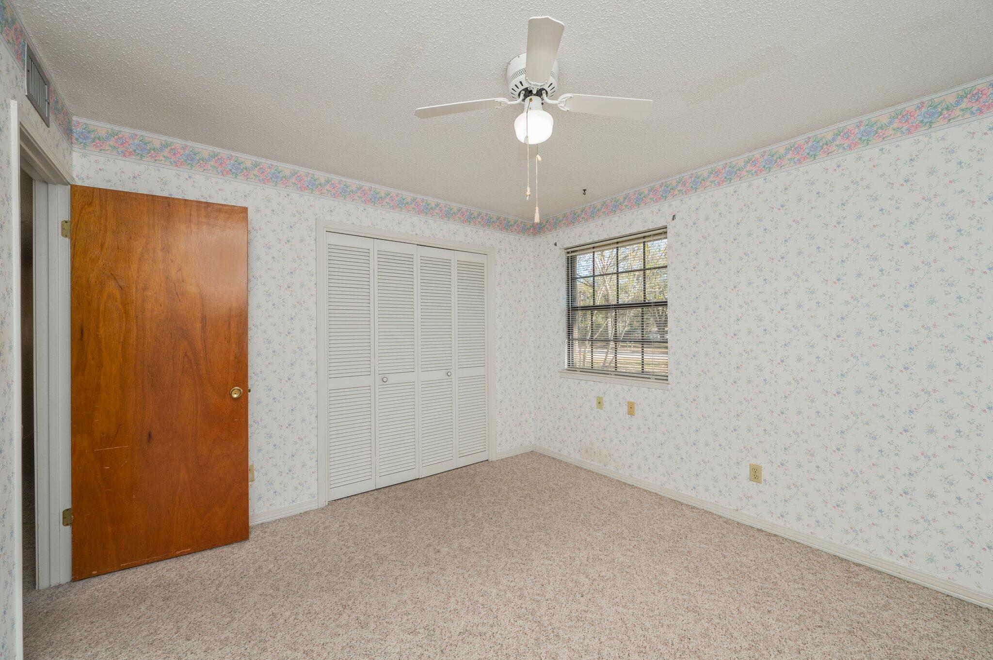 5836 Dairy Road Baker, FL 32531 - Photo 41 of 65 an empty room with windows and fan