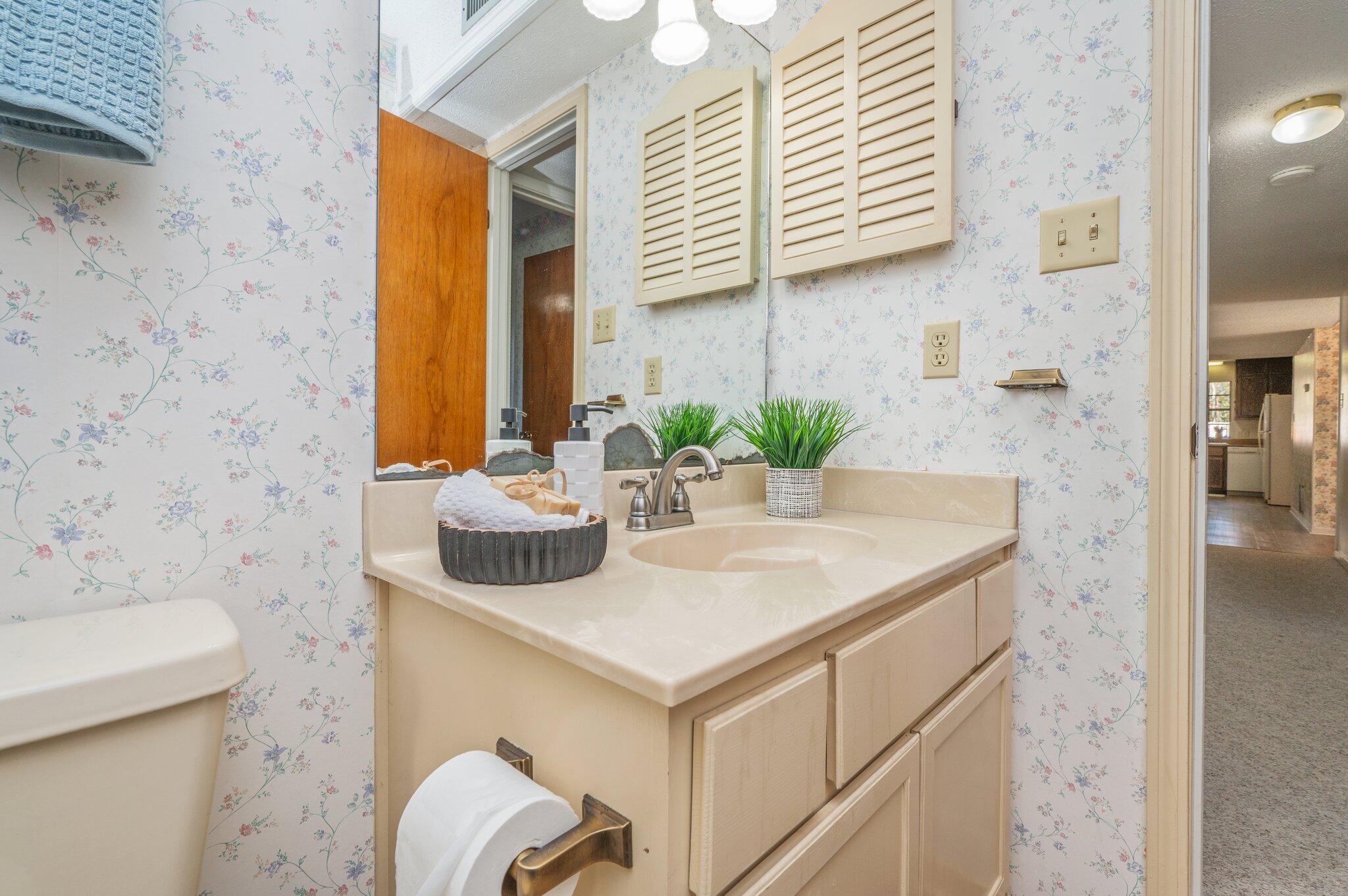 5836 Dairy Road Baker, FL 32531 - Photo 44 of 65 a bathroom with a sink and a mirror