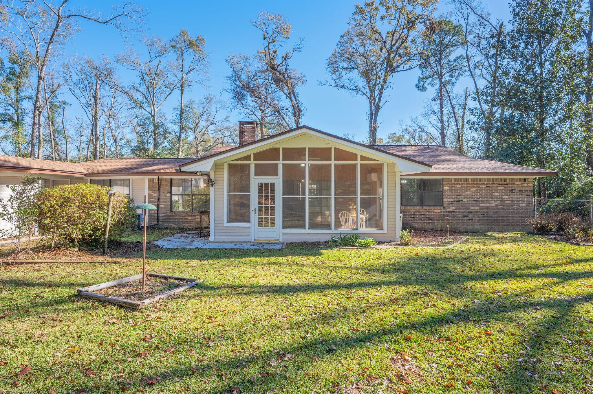 5836 Dairy Road Baker, FL 32531 - Photo 56 of 65 a view of a house with backyard and sitting area