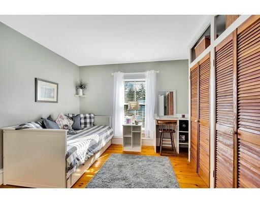 38 Windsor Avenue Acton, MA 01720 - Photo 20 of 30 a living room with furniture a fireplace and a flat screen tv