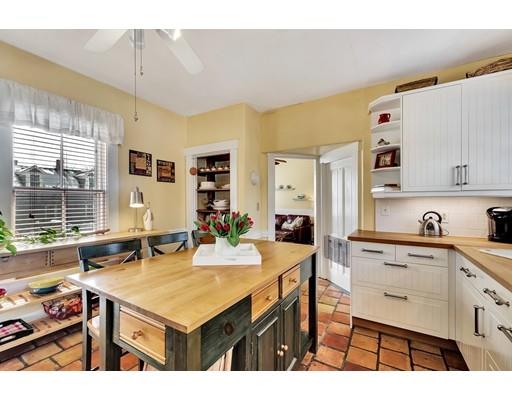 38 Windsor Avenue Acton, MA 01720 - Photo 3 of 30 a kitchen with a stove a refrigerator and a dining table