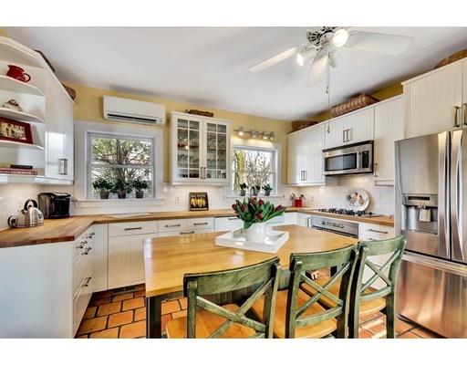 38 Windsor Avenue Acton, MA 01720 - Photo 5 of 30 a kitchen with a table chairs refrigerator and microwave