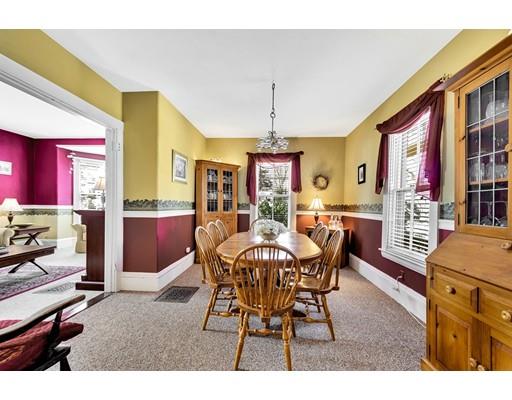 38 Windsor Avenue Acton, MA 01720 - Photo 9 of 30 a view of a dining room and livingroom with furniture wooden floor a rug a flat screen tv