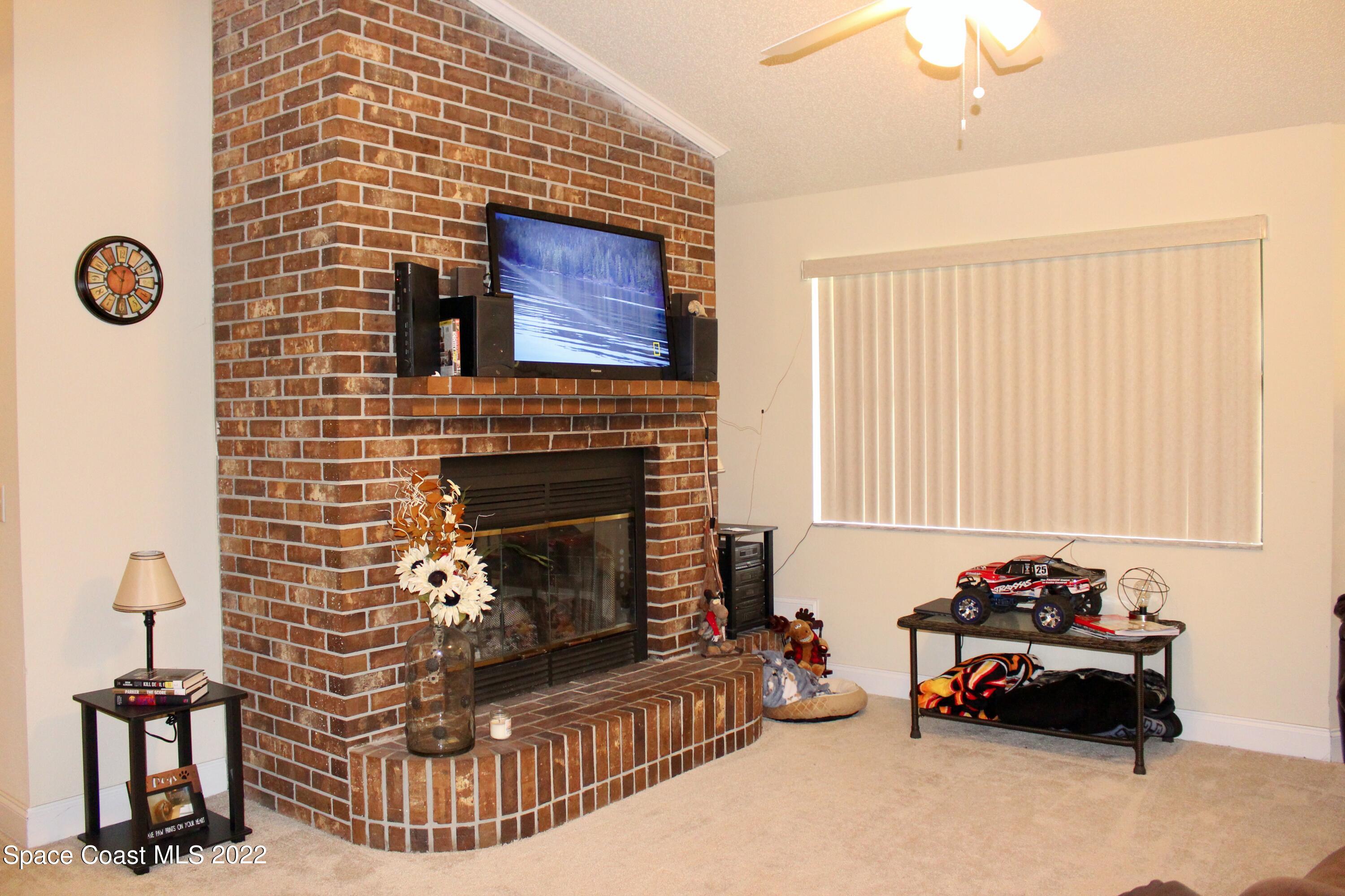 6737 Cecil Road Cocoa, FL 32927 - Photo 13 of 39 a living room with furniture and a fireplace