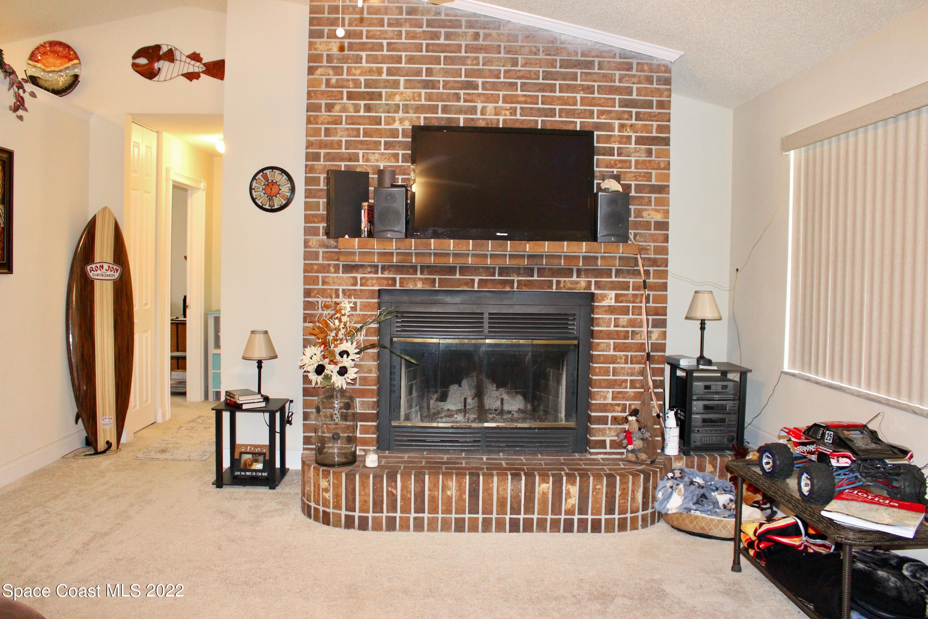 6737 Cecil Road Cocoa, FL 32927 - Photo 14 of 39 a living room with furniture and a fireplace