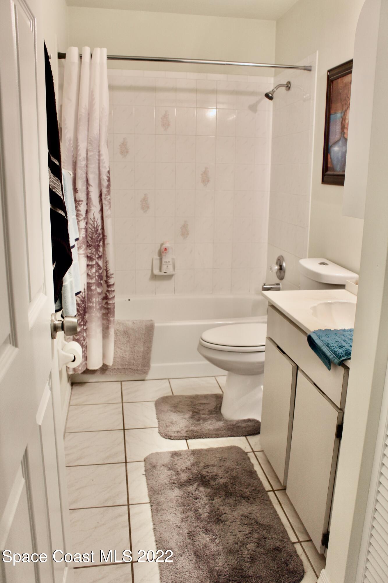 6737 Cecil Road Cocoa, FL 32927 - Photo 16 of 39 a bathroom with a sink a toilet and shower