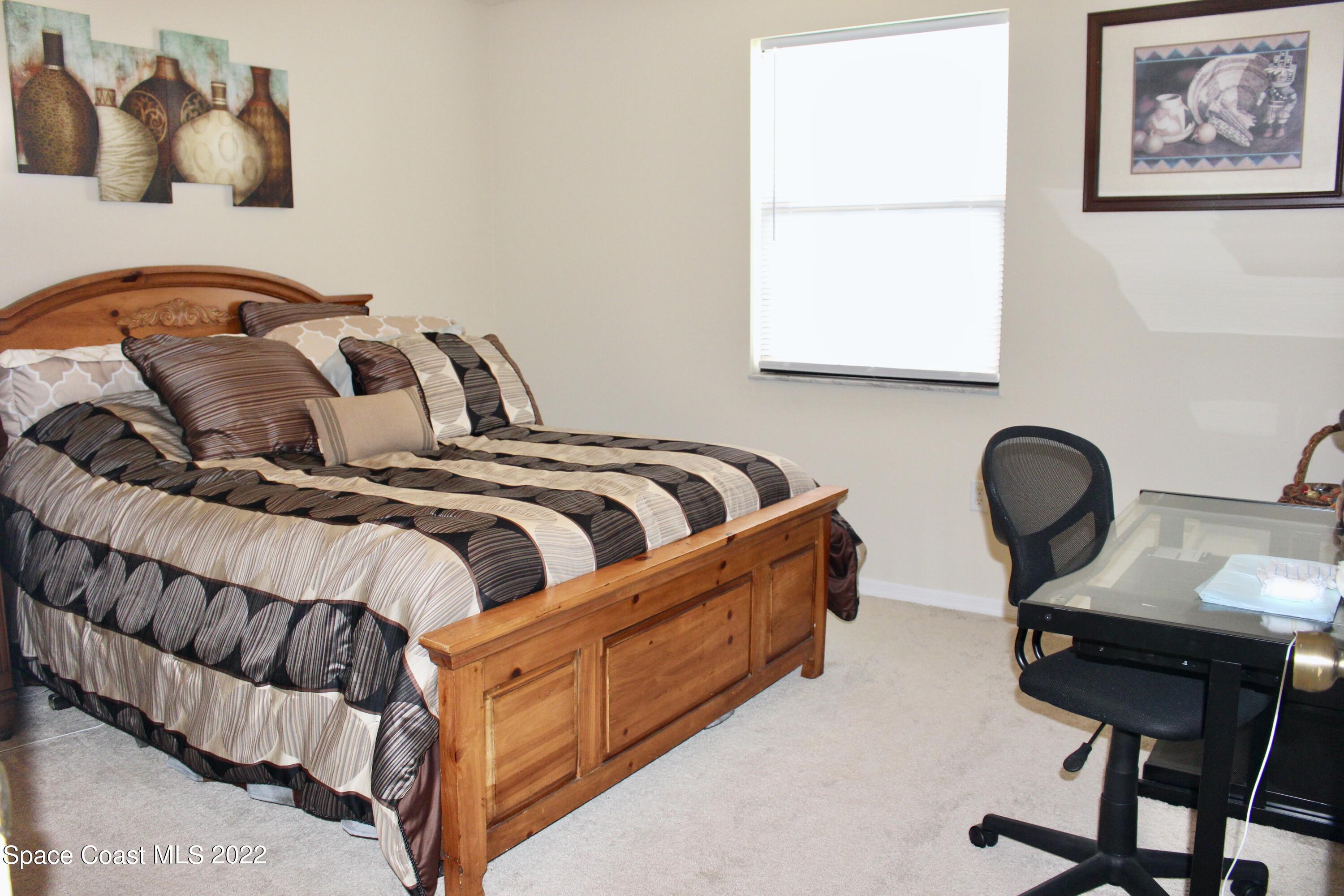 6737 Cecil Road Cocoa, FL 32927 - Photo 18 of 39 a bedroom with bed and a window