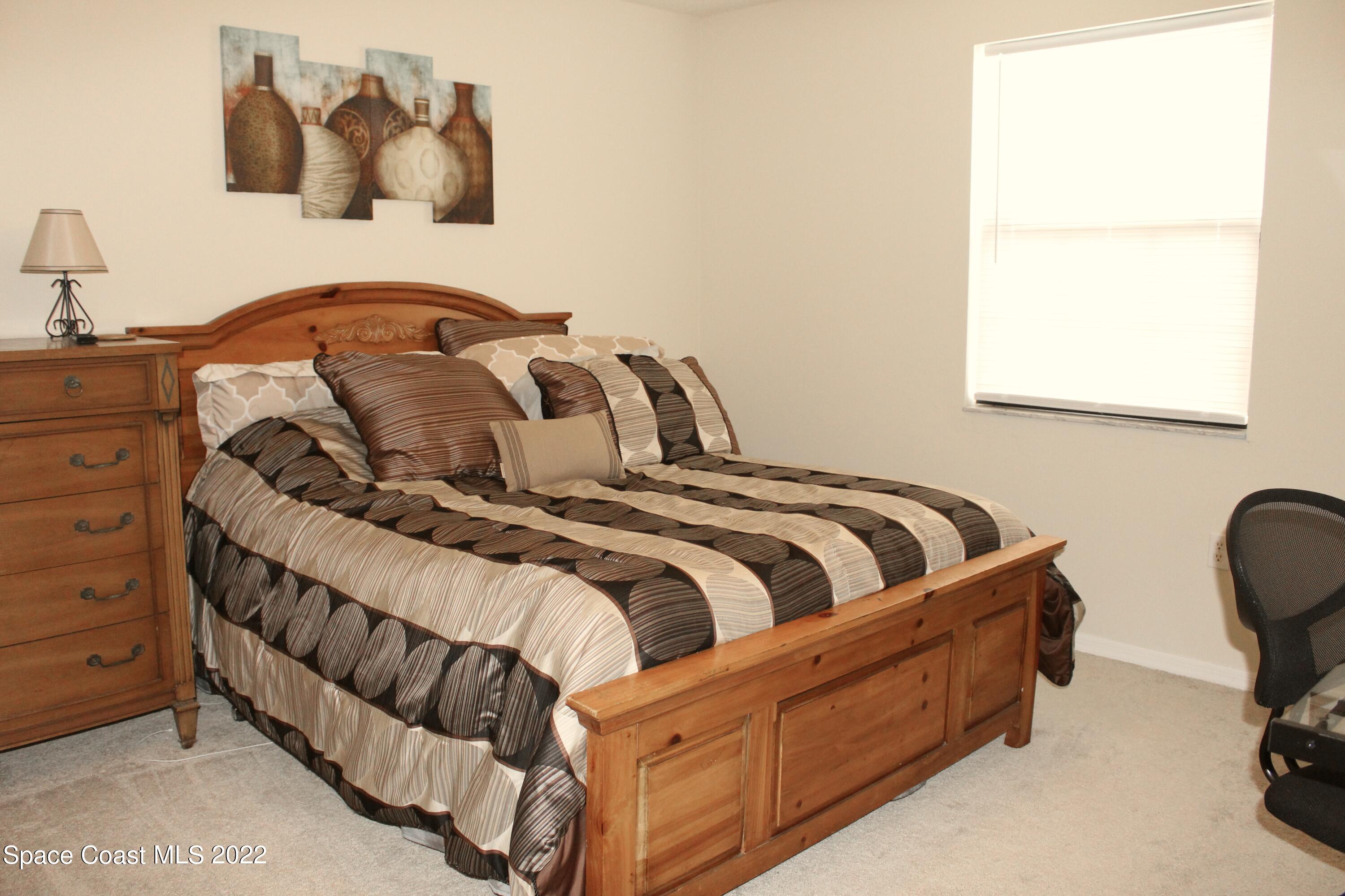 6737 Cecil Road Cocoa, FL 32927 - Photo 19 of 39 a bedroom with a bed and window