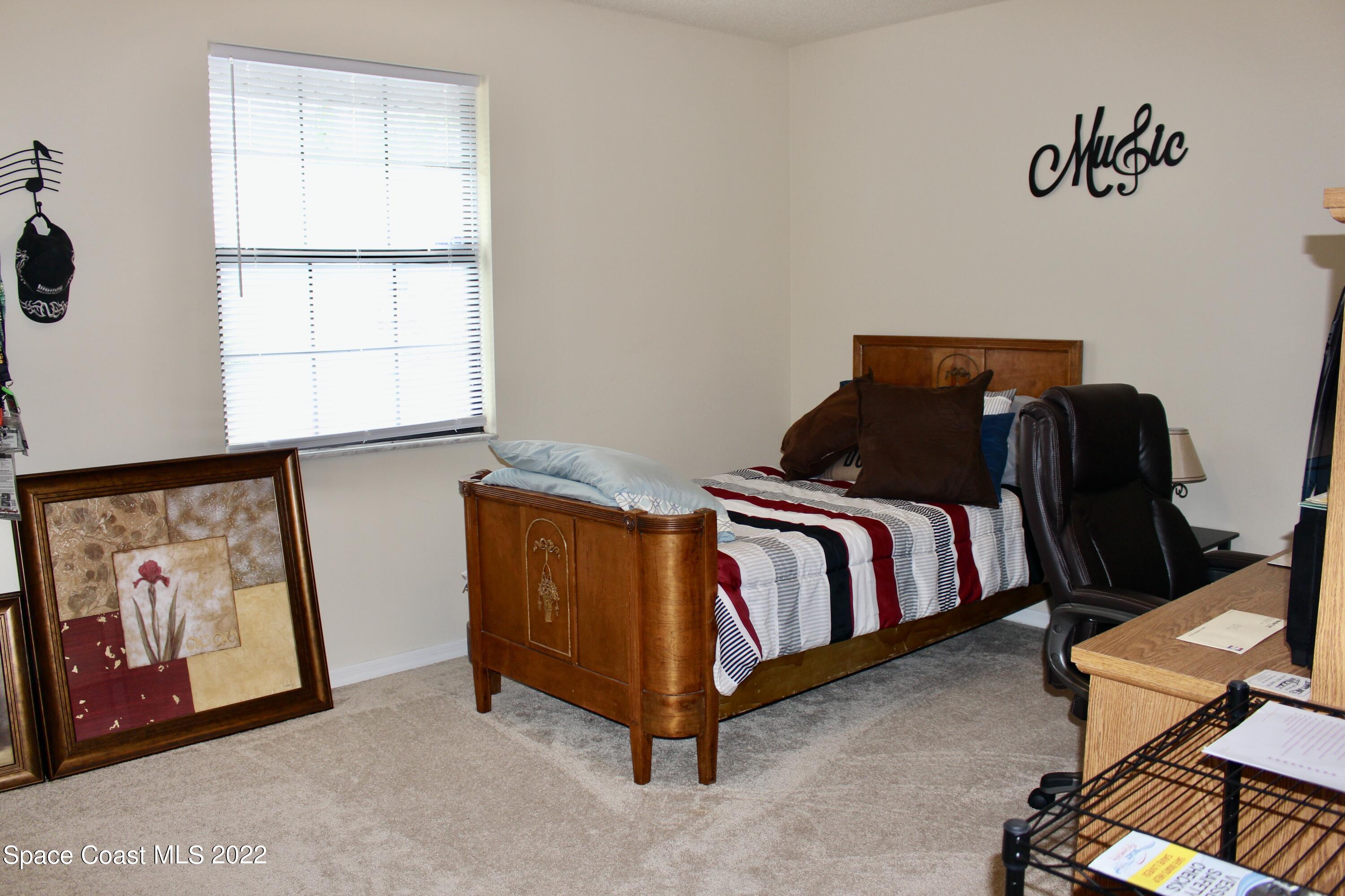 6737 Cecil Road Cocoa, FL 32927 - Photo 20 of 39 a bedroom with a bed and window