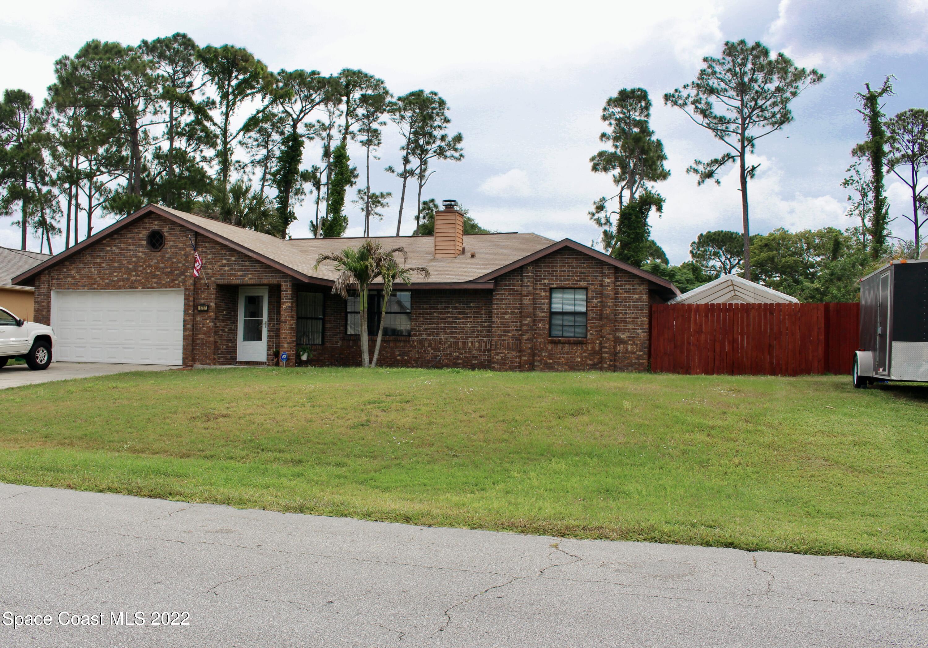 6737 Cecil Road Cocoa, FL 32927 - Photo 2 of 39 a front view of a house with a garden