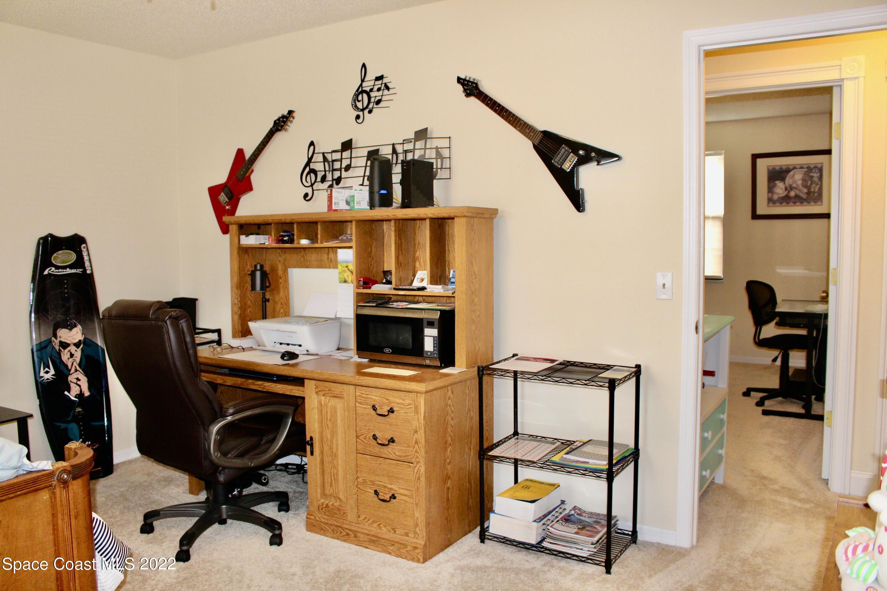 6737 Cecil Road Cocoa, FL 32927 - Photo 22 of 39 a view of a workspace with furniture and gym equipment