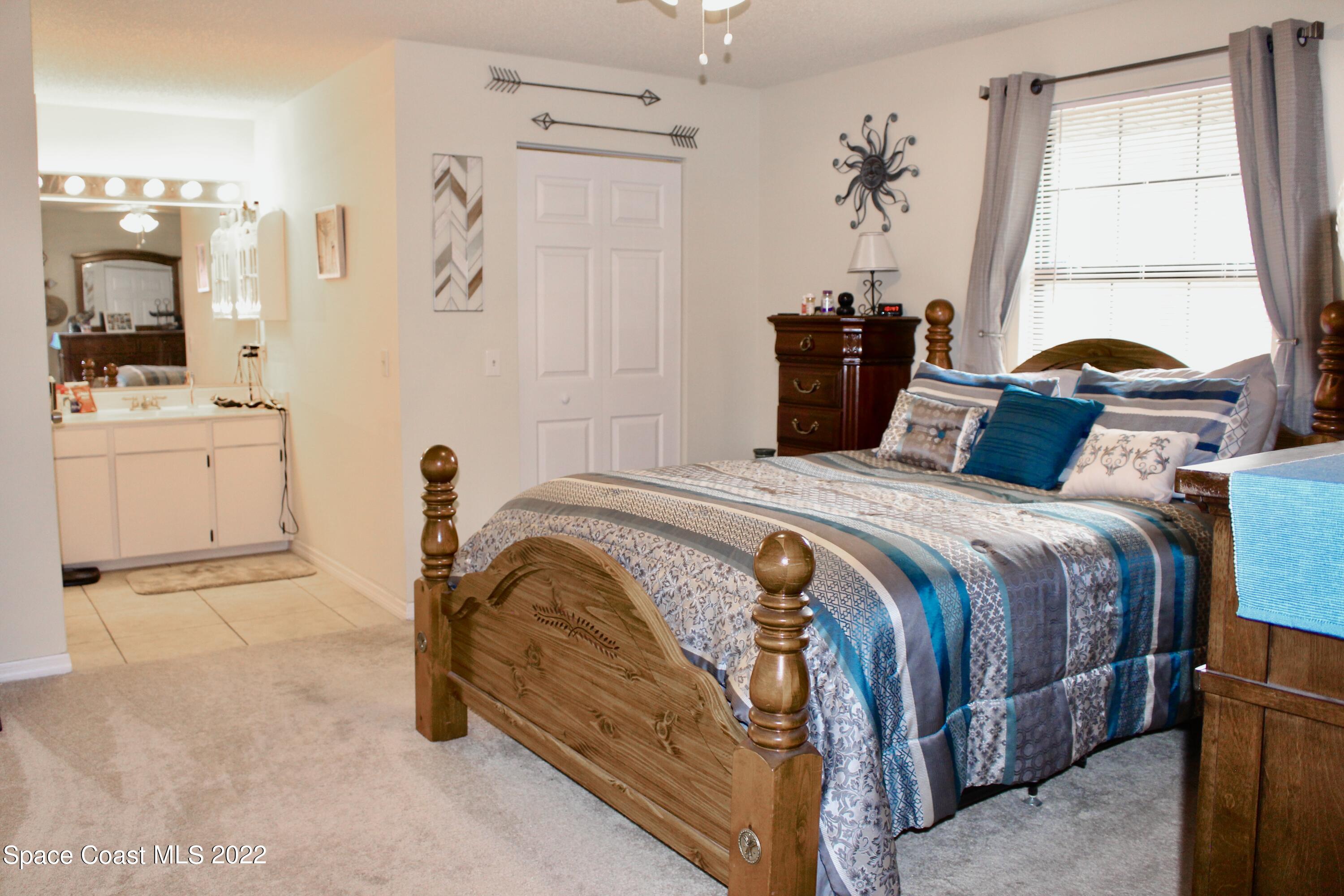 6737 Cecil Road Cocoa, FL 32927 - Photo 23 of 39 a bedroom with a bed and a window
