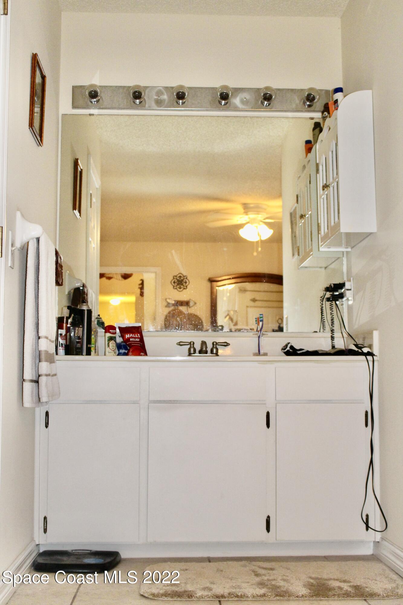6737 Cecil Road Cocoa, FL 32927 - Photo 25 of 39 a kitchen with stainless steel appliances granite countertop a sink and a white refrigerator