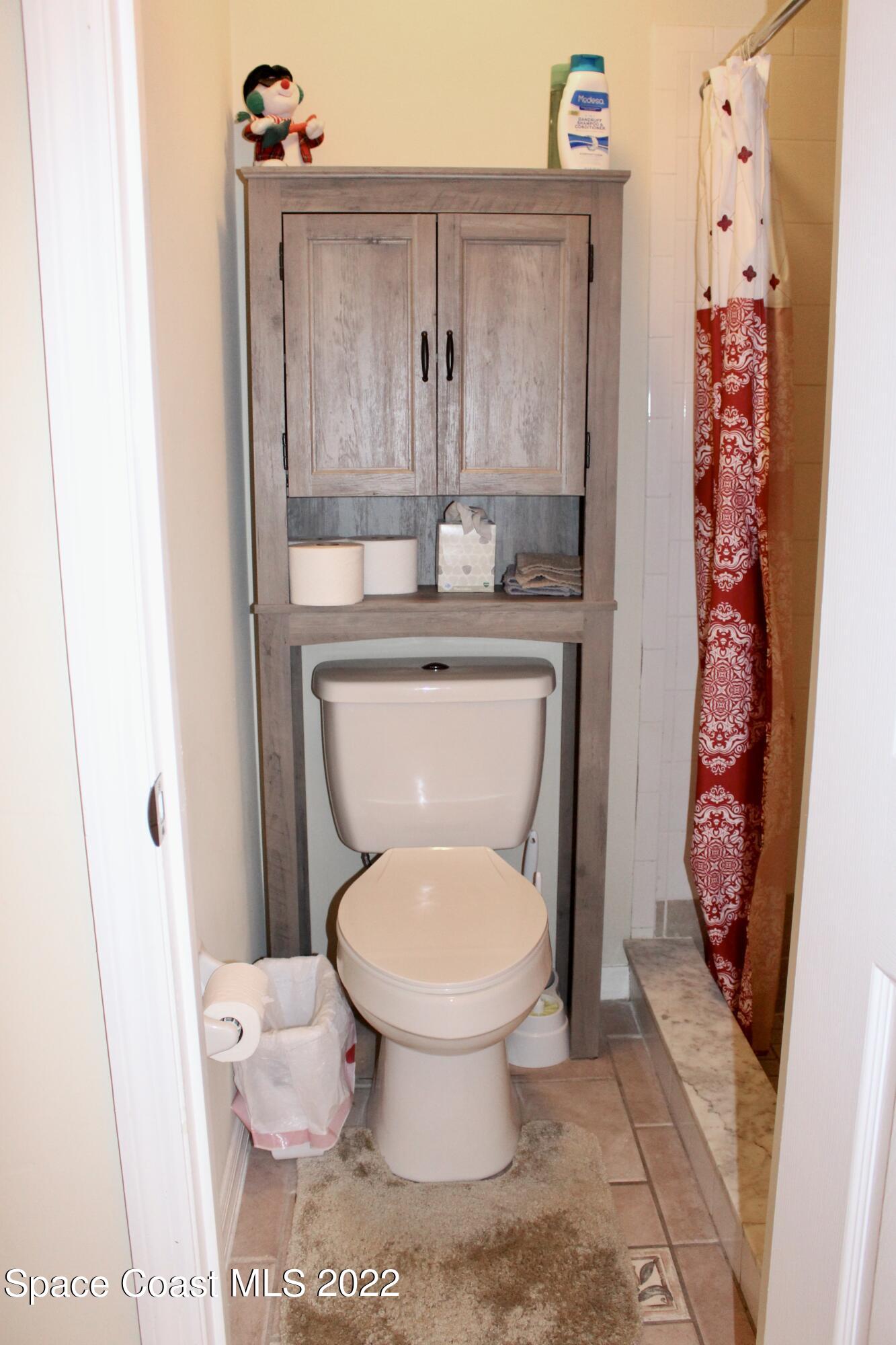 6737 Cecil Road Cocoa, FL 32927 - Photo 26 of 39 a bathroom with a toilet and a sink